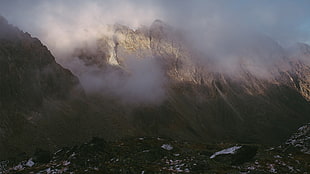 photo of gray mountain covered in clouds, landscape
