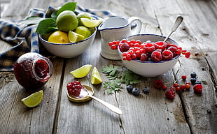 raspberry and green citrus fruits in bowls