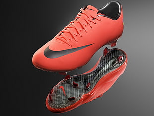 pair of red-and-black Nike cleats