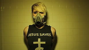 woman in black tank top wearing gas mask white standing