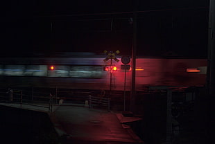 black and red stop light, train, railway crossing, vehicle, night