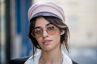woman in pink military cap and brown tint sunglasses taking picture
