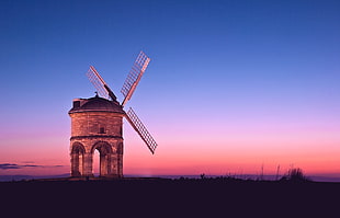 windmill on mountain during sunset