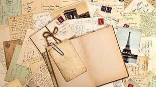 journal surrounded by postcards