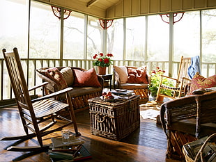 wicker coffee table on terrace with rocking armchair and sofa