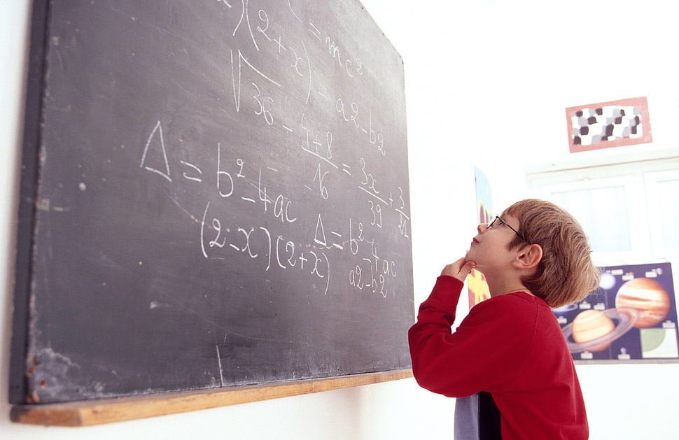 boy in red sweatshirt observing at board with math equation HD wallpaper
