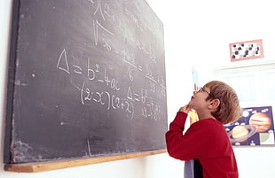 boy in red sweatshirt observing at board with math equation HD wallpaper