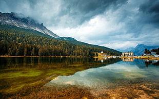 beige concrete house near body of water and mountain, nature, mountains, reflection, trees