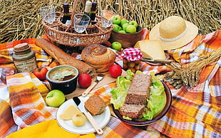 assorted bread, apples, and cheese with wine bottle