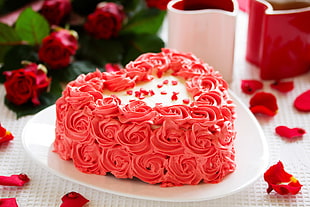 white-and-red-icing heart cake with plate