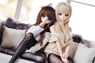 Sex dolls on white couch