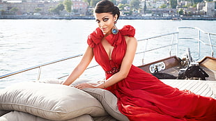 woman in red plunging neckline sleeveless dress posing for a photo