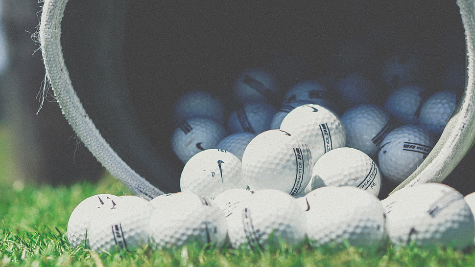 depth of field photography of white golf balls inside container HD wallpaper