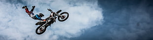 person doing motocross stunt while on the air