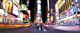 timelapse photogrpahy of people on street with vehicles passing by, neon, city