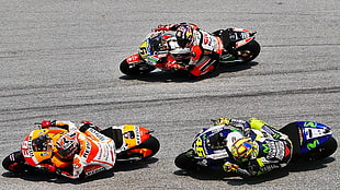 three racer riding sports bikes during daytime HD wallpaper