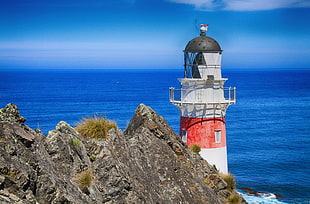 a view of lighthouse under clear blue sky