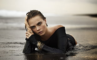 woman wearing black top on body of water HD wallpaper