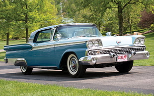 classic blue and white Chevrolet Impala coupe
