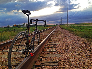 black road bike on train track HD wallpaper