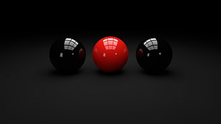 red ball in The middle of two black balls