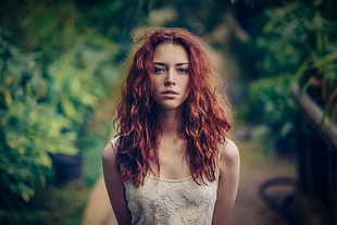 portrait photography of red haired woman in white top