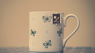 blue and black butterfly print white ceramic mug with teabag