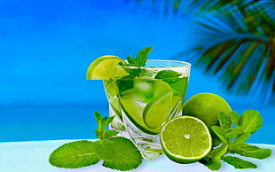 clear glass filled with clear liquid and lime HD wallpaper