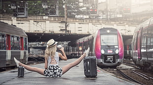 woman in white top doing split position while waiting train HD wallpaper