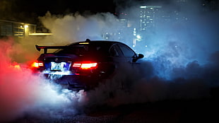 black car with smoke during nighttime