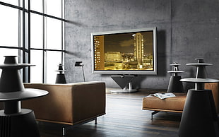 television beside wall and tables