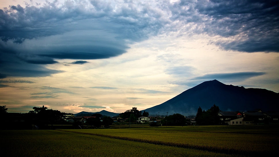 mountain range under gray clouds HD wallpaper