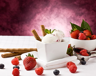 strawberry flavored ice cream scoops on white ceramic bowl