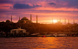 mosques near buildings and body of water during golden hours HD wallpaper