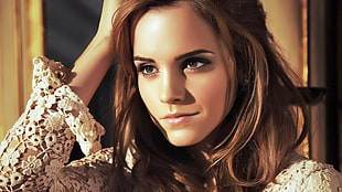 Emma Watson holding her brown hair