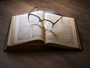 black-framed eyeglasses on top opened book HD wallpaper