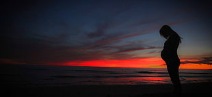 pregnant woman near sea during sunset HD wallpaper