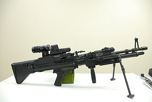 black hunting rifle with tactical scope on table HD wallpaper