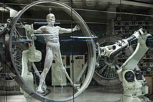 human figure held by robotic hand HD wallpaper
