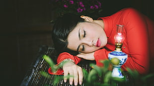 shallow focus photography of woman sleeping on table