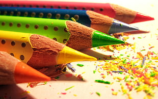 closeup photography of five colors of color pencils