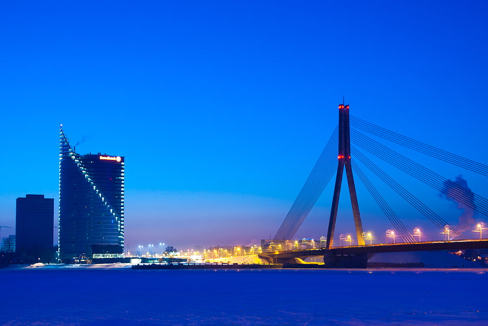 photo of cityscale during night time, riga, cable bridge, latvia HD wallpaper