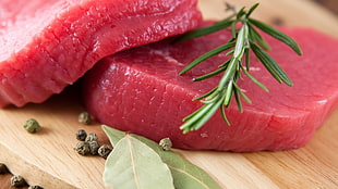 raw meat on brown wooden chopping board
