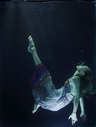 underwater photography of woman wearing floral home dress