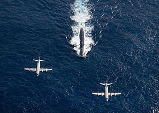 two white airplanes, submarine, p3c orion, military, aerial view
