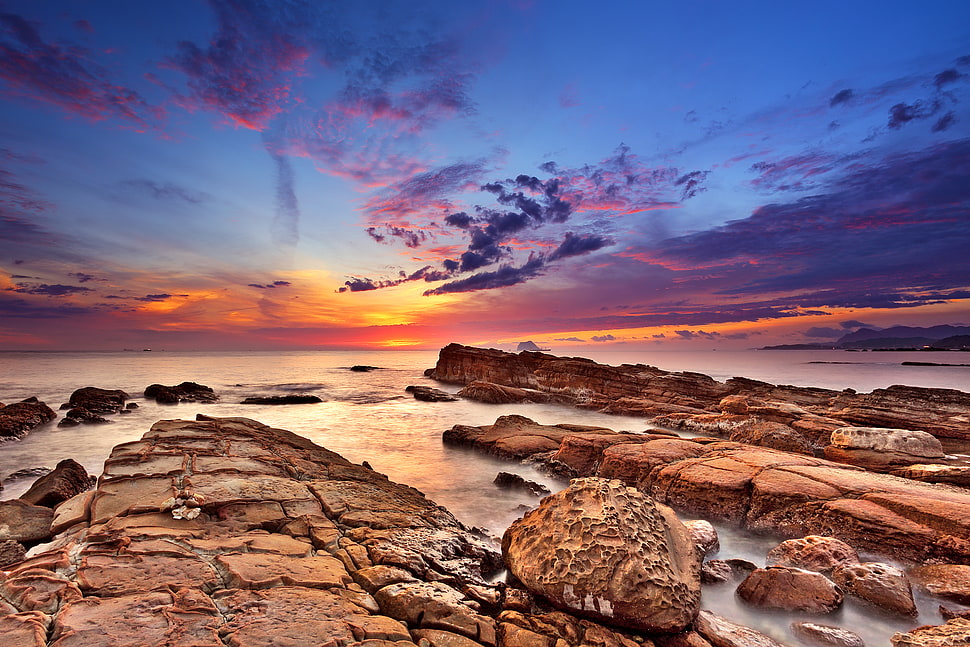 rock formation near body of water during sunset HD wallpaper