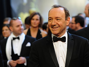 closeup photo of man in black tuxedo smiling
