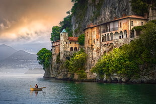 person riding on boat near house on mountain cliff digital wallpaper, Italy, Hermitage, cliff, clouds HD wallpaper