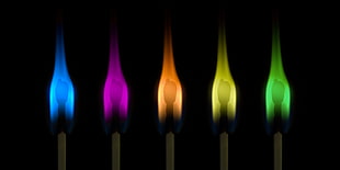 five assorted color matchstick flames with black background