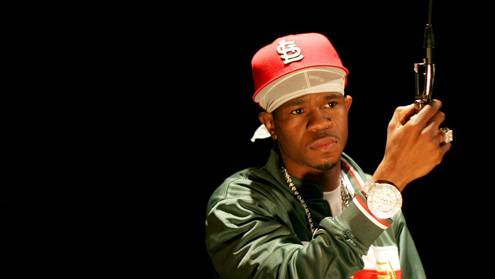 man in green jacket with red fitted cap HD wallpaper